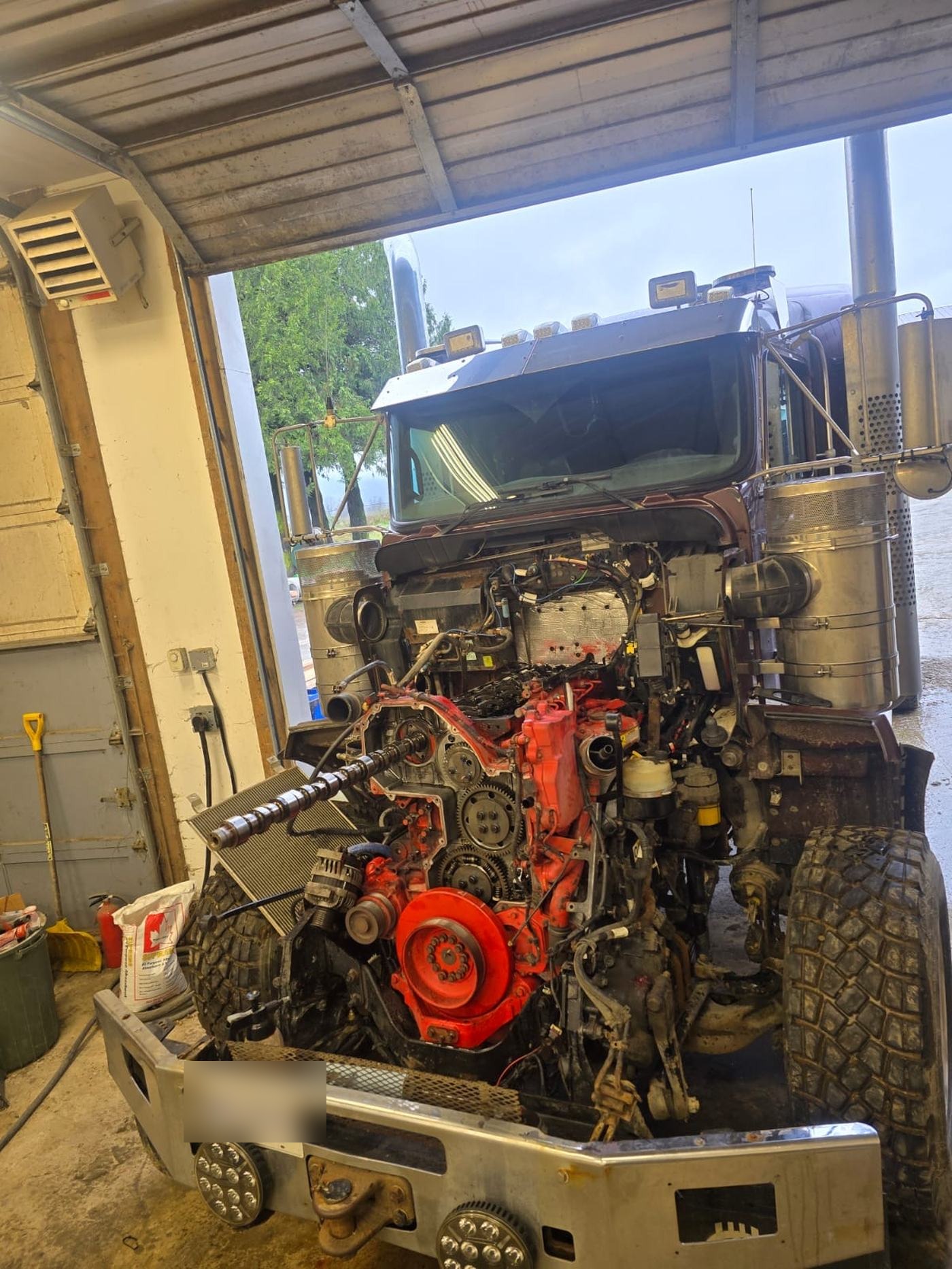 Mazdock mechanic performing in-shop engine repair on a commercial truck, Agassiz BC